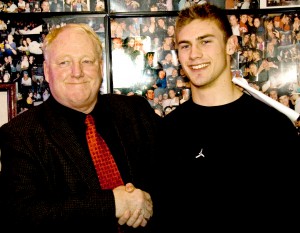 Craig Howard, SOU's head football coach shakes hands with Matt Retzlaff, the 17-year old from South Medford who just signed on with the Raiders, during the signing party at Louie's on Wednesday. Photo by Troy Goossen/The Siskiyou