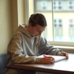 Katlyn Carney studies near a window at Southern Oregon University's Hannon Library