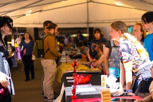 Young woman leans on table at event