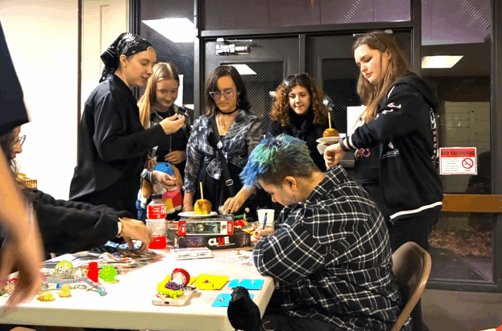 A group of students surround a table on work on crafts