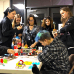 A group of students surround a table on work on crafts