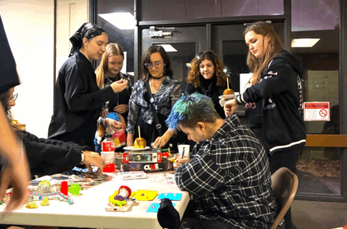 A group of students surround a table on work on crafts