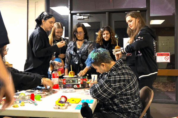 A group of students surround a table on work on crafts