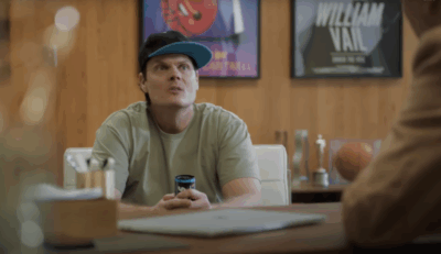 Internet personality Skweezy Jibbs sits near desk in film producer's office