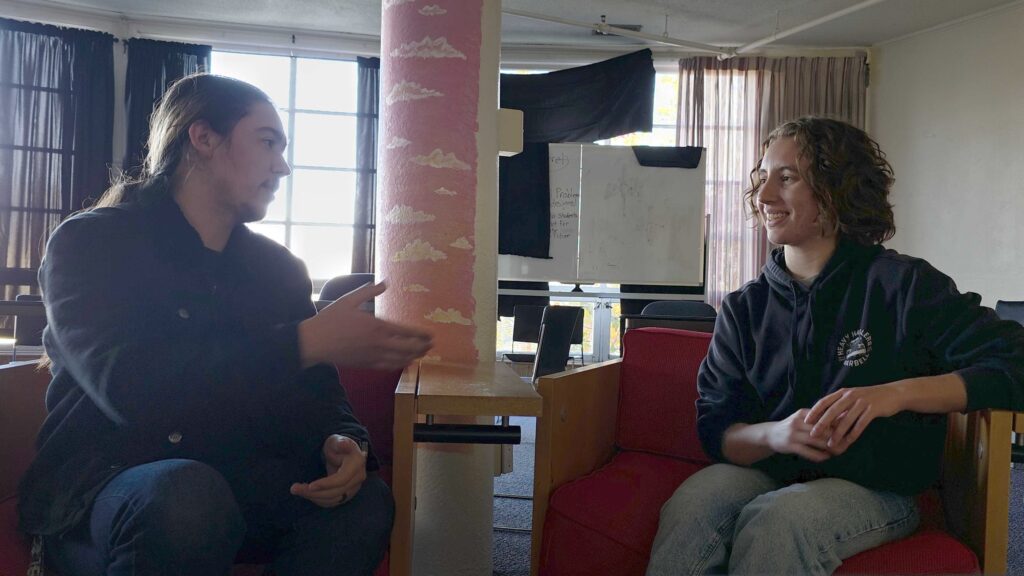 Siskiyou student journalist Mathew Peterson converses with event organizer Maisie Bandel-Ramirez