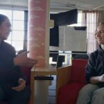 Siskiyou student journalist Mathew Peterson converses with event organizer Maisie Bandel-Ramirez