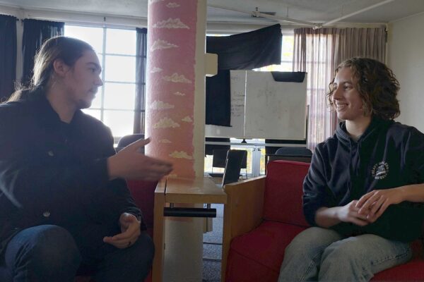 Siskiyou student journalist Mathew Peterson converses with event organizer Maisie Bandel-Ramirez