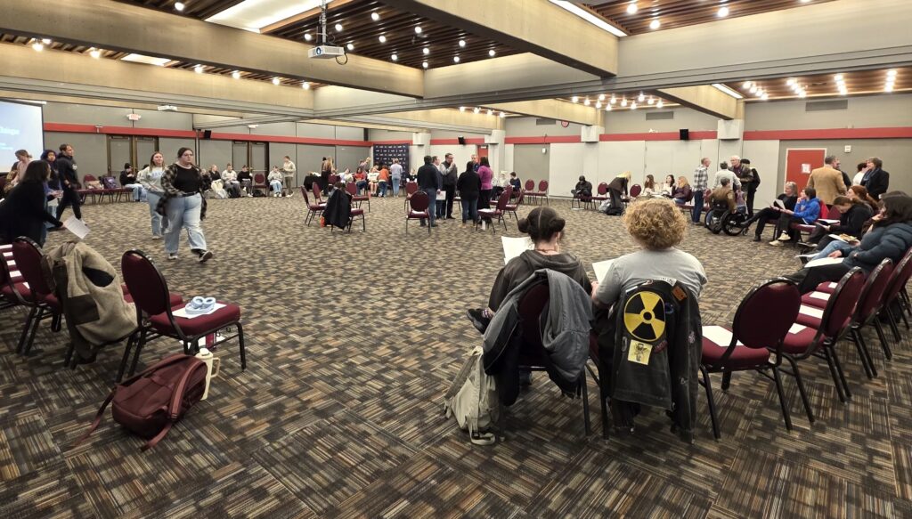 Students seated in a large circle at Southern Oregon University's student union during a forum on youth politics and engagement