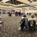 Students seated in a large circle at Southern Oregon University's student union during a forum on youth politics and engagement