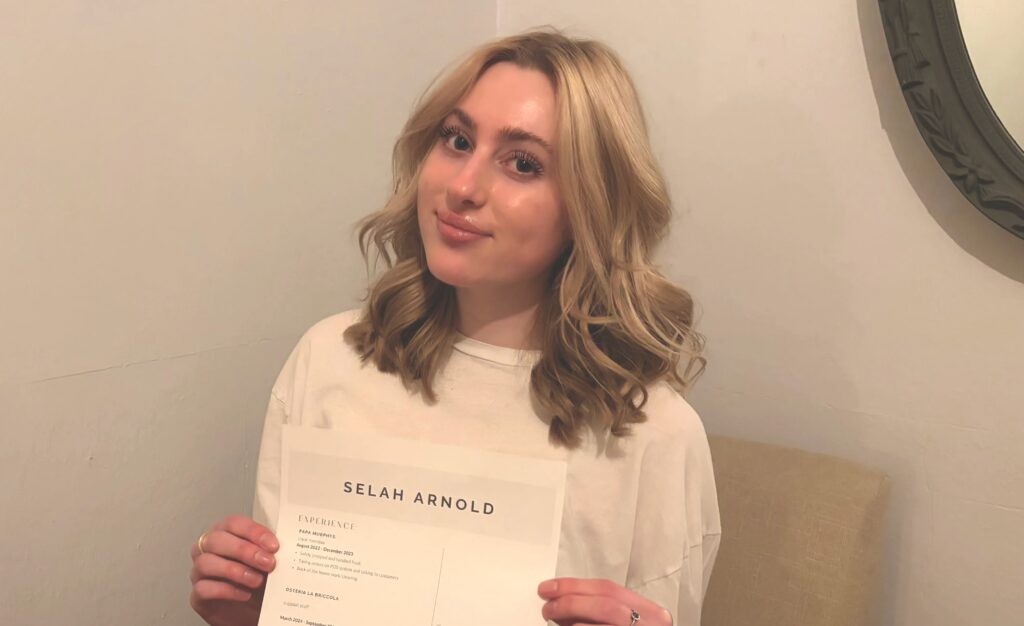 Young woman holds document with resume