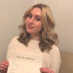 Young woman holds document with resume