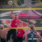 SOU beach volleyball player spikes the ball at NAIA championship tournament