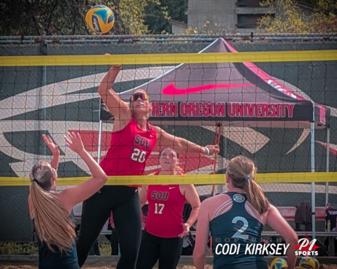 SOU beach volleyball player spikes the ball at NAIA championship tournament