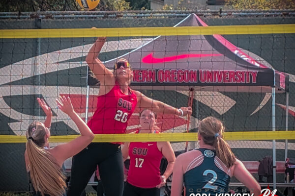 SOU beach volleyball player spikes the ball at NAIA championship tournament
